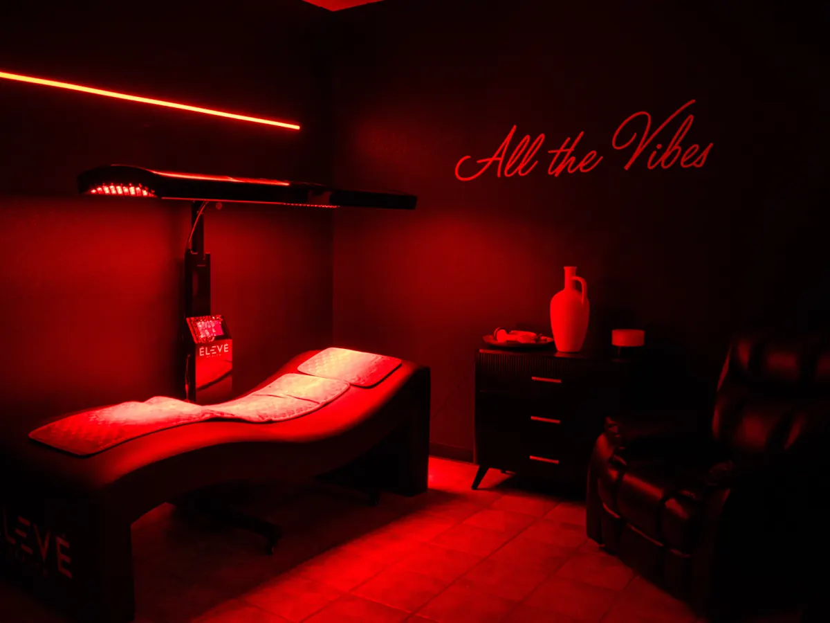 Red light therapy room with a treatment table at Flex Factory Nutrition and Wellness